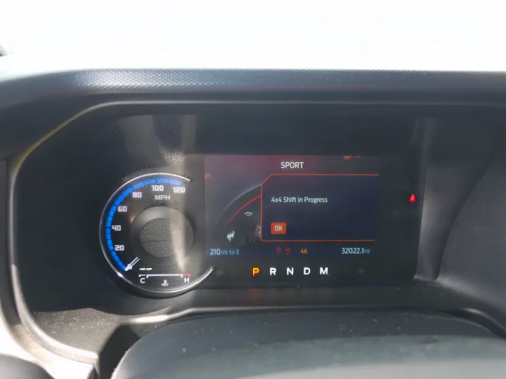 RV rental dashboard displays '4x4 Shift in Progress' message, SPORT mode, and 32022.1 miles. Vehicle is in Park.. Ford Bronco Outer Banks 2022