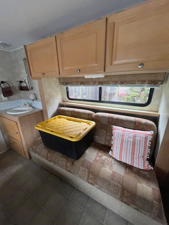 RV rental interior with a compact bathroom, cozy dinette, window views, & storage.. Thor Motor Coach Wave 2007
