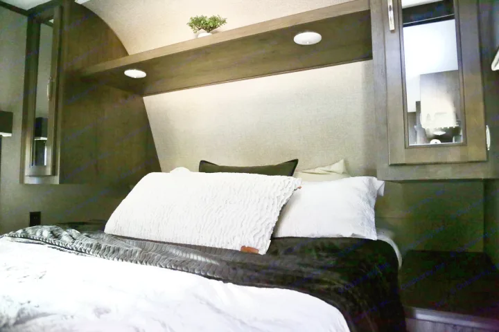 Modern RV rental bedroom features a plush bed, built-in shelving, and mirrored cabinets, offering comfort on the road.. Jayco Jay Flight SLX 2020
