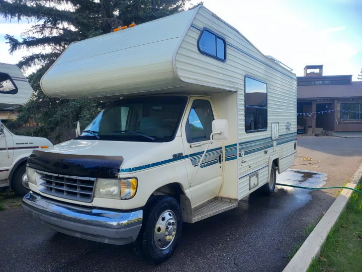 This white Ford E350 Class C RV rental appears freshly washed and ready for adventure.. Ford Econoline 1992