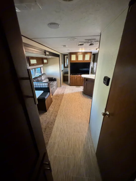 View from a doorway into an RV rental's interior.. Forest River Avenger ATI 2018