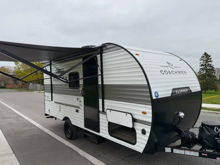 A sleek Coachmen Clipper travel trailer with extended awning, ready for your next RV rental trip.. Coachmen Clipper 17CBH 2025