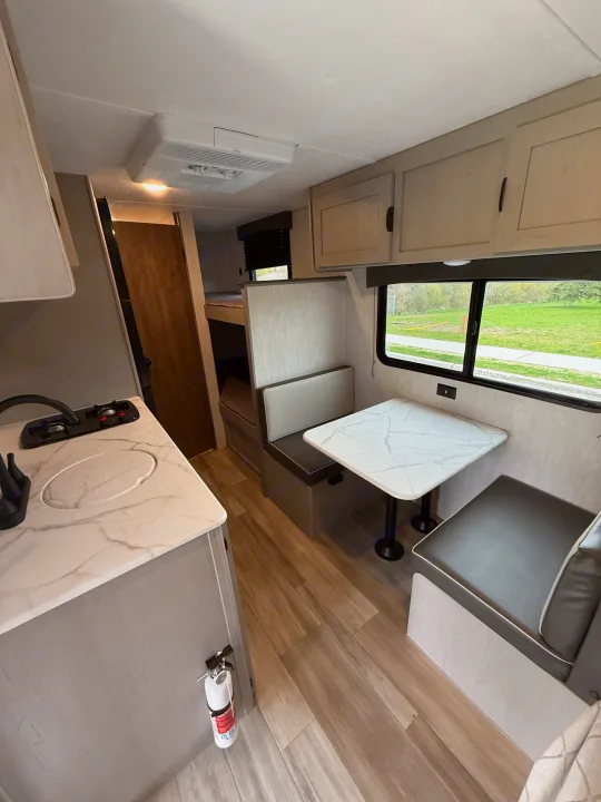 This rv rental features a modern interior with a kitchen, dinette, and bunk beds, ready for your travels.. Coachmen Clipper 17CBH 2025