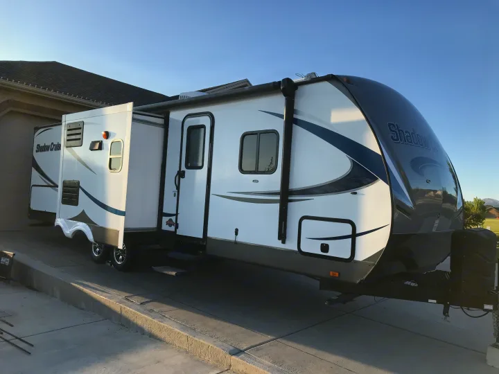 This sleek white and grey Shadow Cruiser travel trailer, with a slide-out, is perfect for an RV rental adventure.. Cruiser RV Shadow Cruiser 2015
