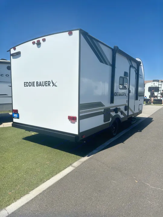 Experience the outdoors with this Eddie Bauer rv rental. A white travel trailer is parked, ready for adventure.. Heartland Eddie Bauer 2025