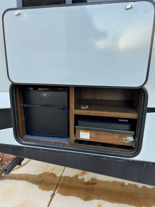 This RV rental features a convenient outdoor kitchen: a small fridge and pull-out cooktop for camping meals.. Keystone RV Bullet Ultra Lite 2019