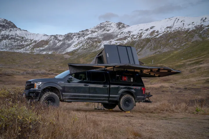 Overland F-150 with rooftop tent & awning deployed in mountains. Explore unique landscapes like this with an adventure RV rental!. Ford Ford F150 2020