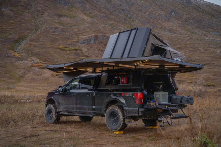 This rugged overlanding Ford F-150, equipped with a rooftop tent and lighted awning, offers the ultimate RV rental adventure in nature.. Ford Ford F150 2020