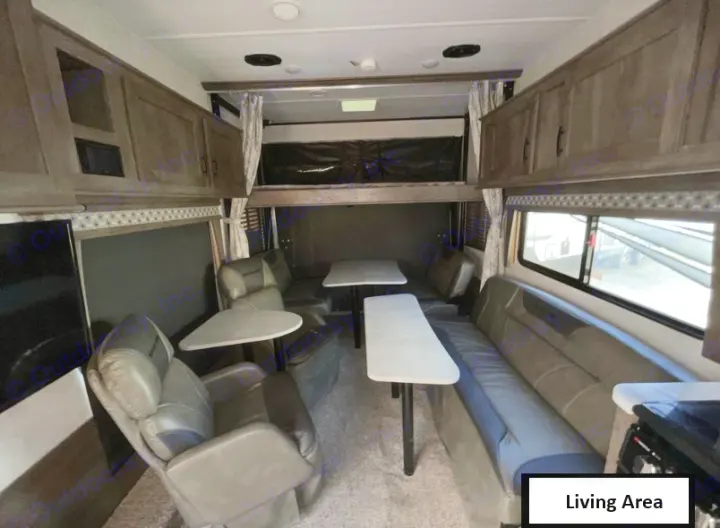 RV rental's versatile interior: a living space with recliners, dinette, and a rear multi-use area featuring an overhead bunk.. Forest River Shockwave 2021