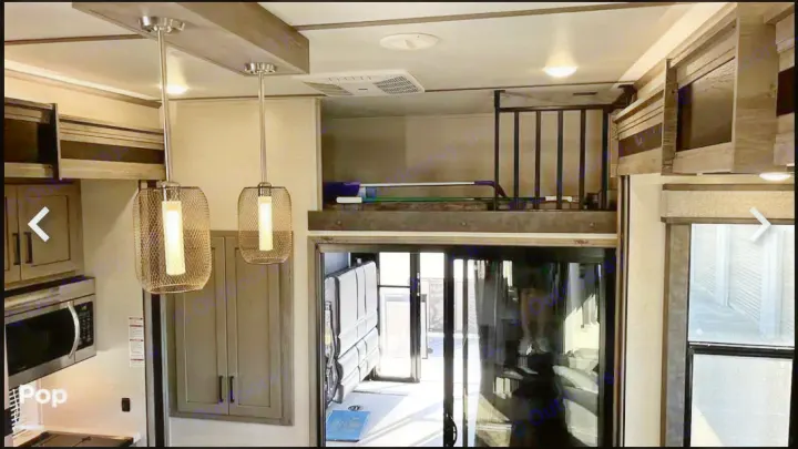 Modern RV rental interior with kitchen, loft, and rear toy hauler garage access. Spacious layout for adventure.. Keystone RV Raptor Toy Hauler 2020