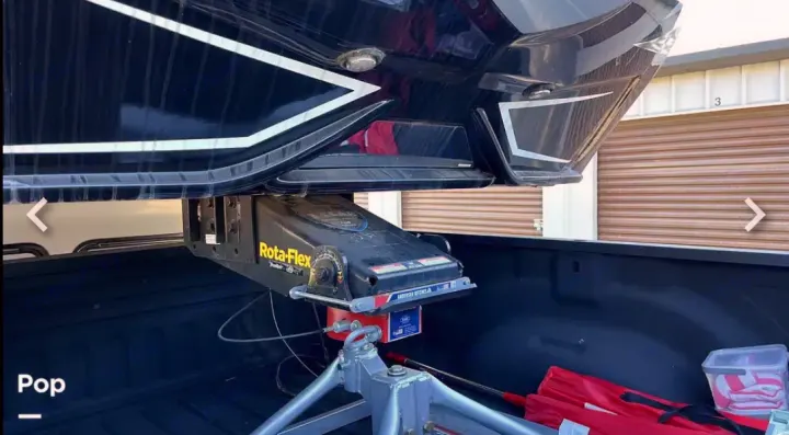 Hooking up a large black fifth-wheel RV rental to a pickup truck using a specialized Rota-Flex hitch system.. Keystone RV Raptor Toy Hauler 2020