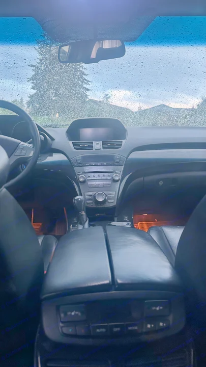 Cozy car interior on a rainy day, footwell lights on. Wet windshield reveals mountains. Ideal vehicle for an RV rental getaway.. Other Other 2007