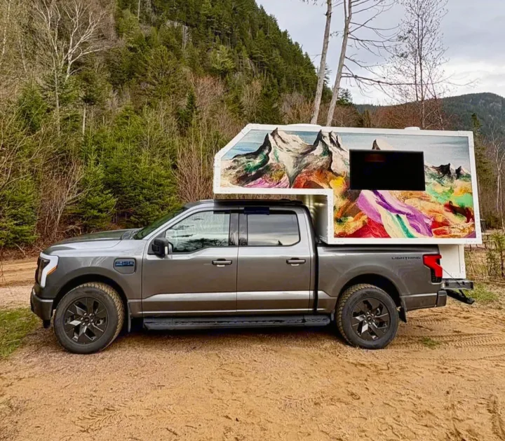 Electric Ford F-150 Lightning with a custom artistic truck camper. Ideal for unique rv rental adventures.. Ford Lightning 2024