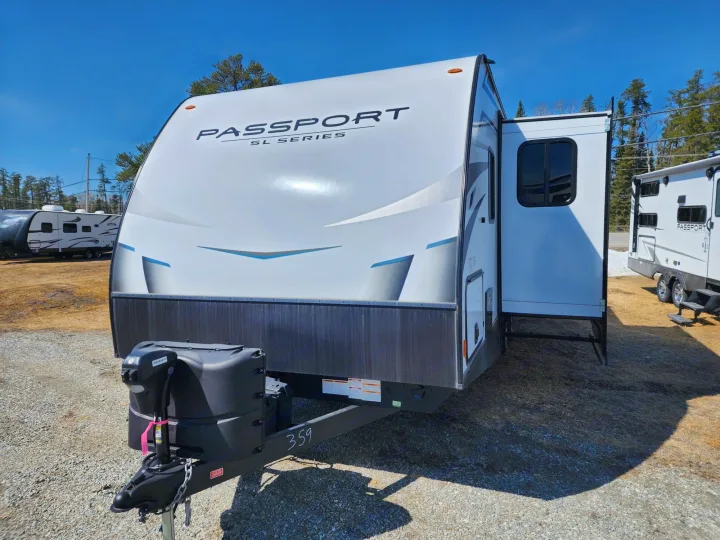 This white Passport SL Series travel trailer, with its slide-out extended, is ready for your next RV rental adventure.. Keystone Passport 2020
