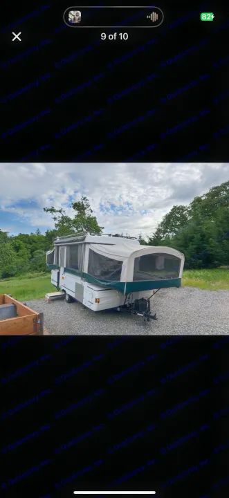 White & green pop-up camper RV rental, expanded on gravel, ready for outdoor adventures.. Coleman Grand Tour 2002