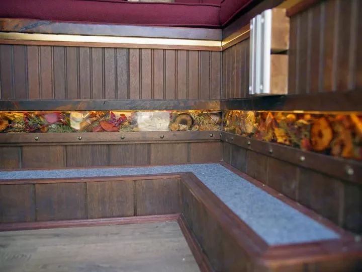Cozy rv rental interior: custom wood, backlit botanicals, comfy bench, and steps.. Dodge Ram Promaster 3500 2023