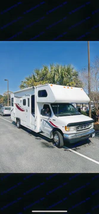 This white RV rental is parked on a sunny day with palm trees, ready for family travel adventures.. Gulf Stream Ultra 1998