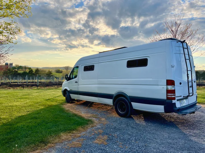 White Sprinter camper van, a perfect RV rental, parked at a picturesque vineyard during a golden sunset.. Dodge Sprinter 3500 2007