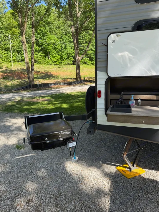 This RV rental shows an outdoor kitchen setup with a sink & grill, perfect for campsite cooking.. Dutchmen Coleman Lantern 2019