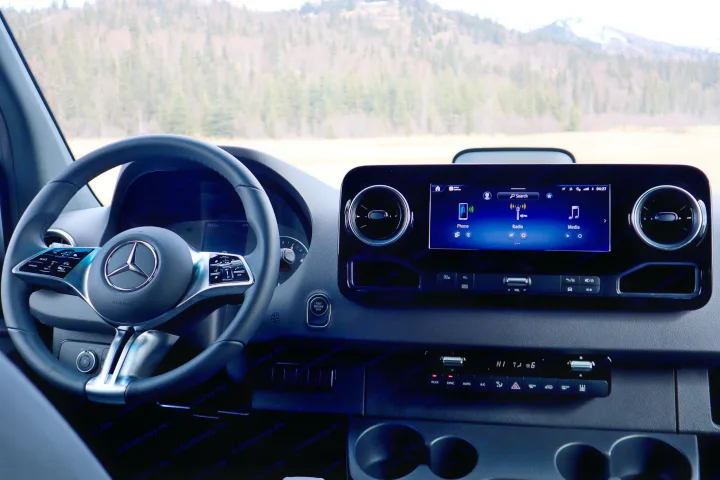 Dashboard view of a premium RV rental, featuring a Mercedes steering wheel & smart infotainment for your adventure.. Mercedes-Benz Sprinter 2025