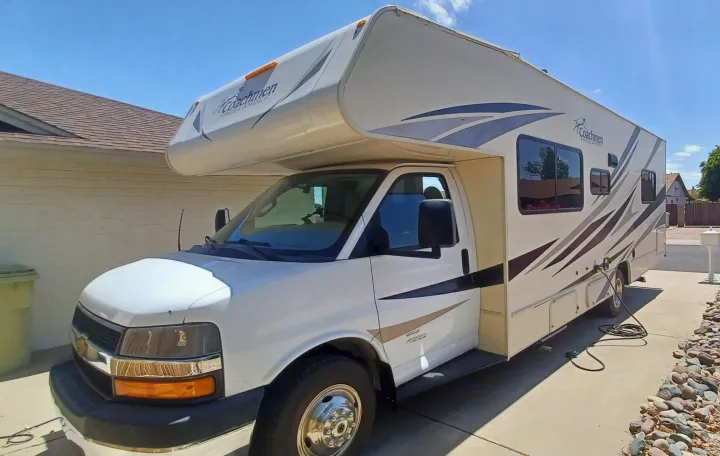 Bright white Coachmen Class C motorhome RV rental, parked on a paved driveway in bright sunlight.. Forest River Coachmen Freelander 2019