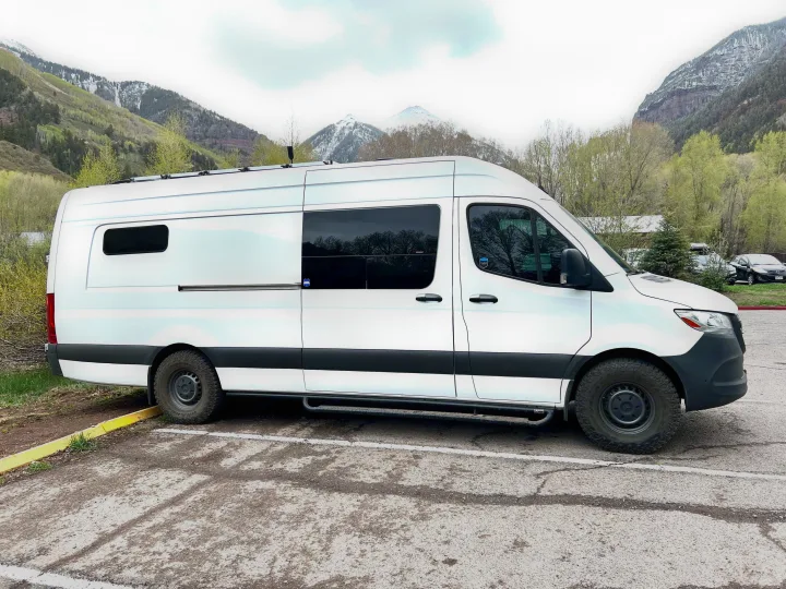 White Sprinter RV rental van in a mountain setting, ideal for adventure & road trips.. Mercedes-Benz Sprinter 2020