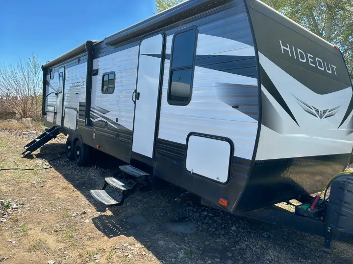Ready for adventure: This clean Hideout travel trailer, a great option for an RV rental, is parked outdoors with steps down.. Keystone RV Hideout 2020