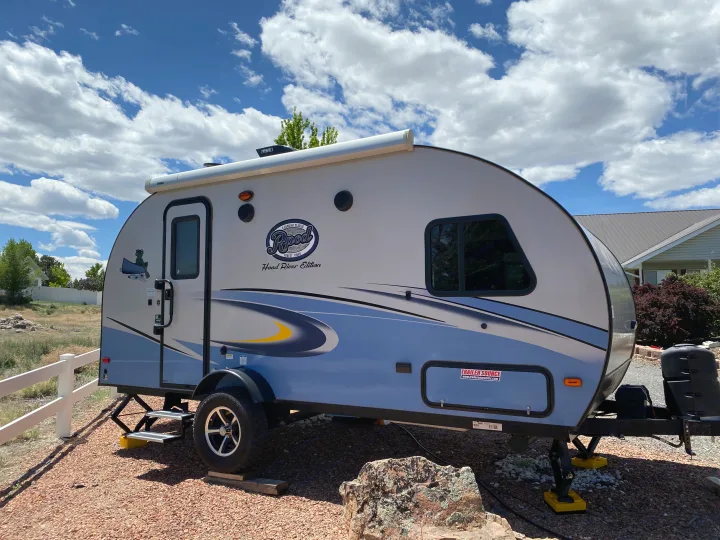 A light blue and white Forest River R-Pod travel trailer, great for an RV rental, parked on gravel under a bright sky.. R-Pod Hood River Edition 2018