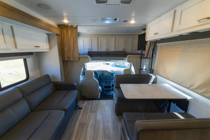 Spacious RV rental interior with sofa, dinette, and cockpit view, offering comfort for your travel adventures.. Gulf Stream Conquest 2024