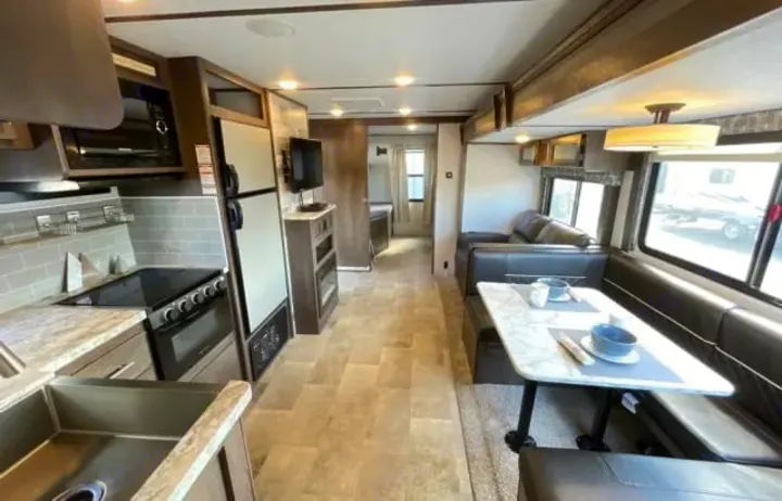 RV rental: Modern interior featuring a full kitchen, comfortable dining area with U-shaped dinette, and living space.. Dutchmen Coleman Light 2020