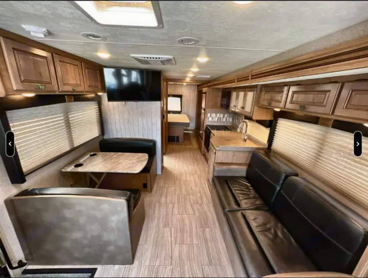 Experience comfort in this RV rental's modern interior, featuring a living area, dinette, and full kitchen.. Thor Windsport 2019