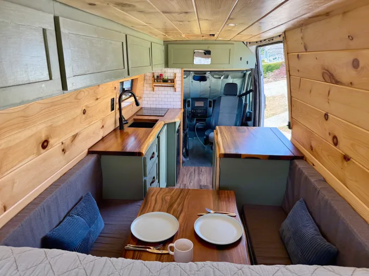 Explore this cozy RV rental camper van! Features a kitchen, dining area, and wood paneling for comfortable adventures.. Dodge Sprinter 3500 2007