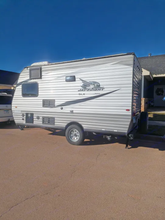 Jayco Jay Flight SLX travel trailer for your next RV rental, parked outside a home under a blue sky.. Jayco Jay Flight SLX 2021