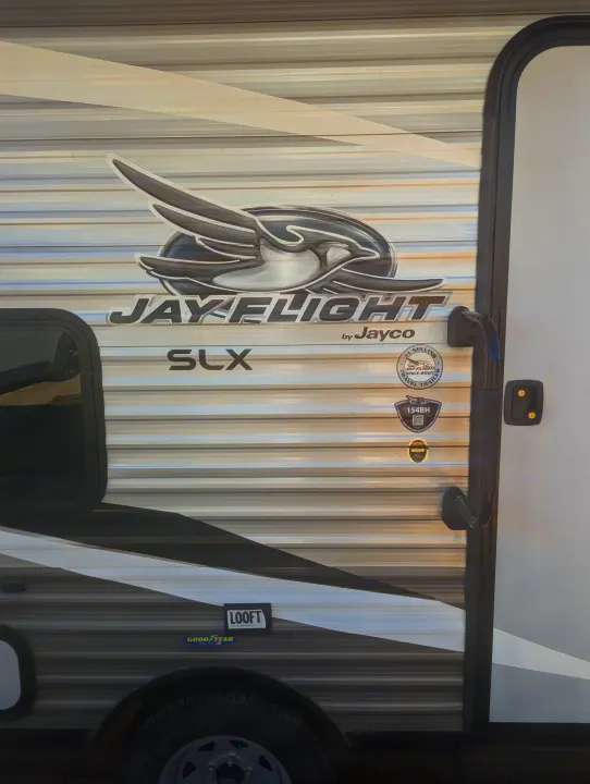 Side view of a grey and white Jayco Jay Flight SLX travel trailer, ideal for an RV rental adventure.. Jayco Jay Flight SLX 2021