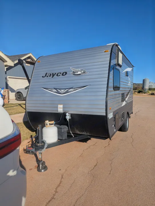 Jayco travel trailer parked in front of a home, ready to be your next RV rental.. Jayco Jay Flight SLX 2021