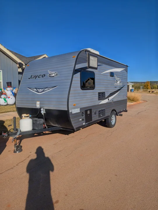 A sleek grey Jayco Jay Flight SLX travel trailer, perfect for an RV rental getaway, seen on a sunny day.. Jayco Jay Flight SLX 2021
