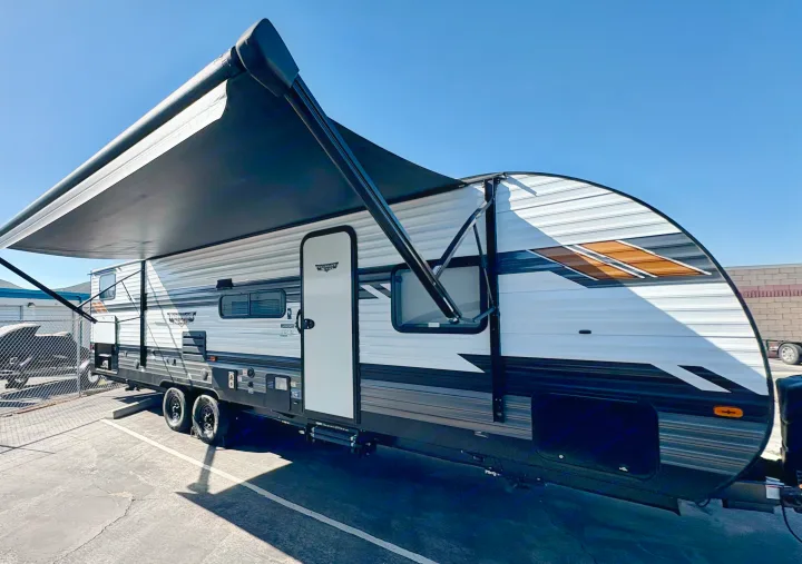 This travel trailer RV rental, featuring an extended awning, is perfect for your next camping adventure or road trip.. Forest River Wildwood X-Lite 2022
