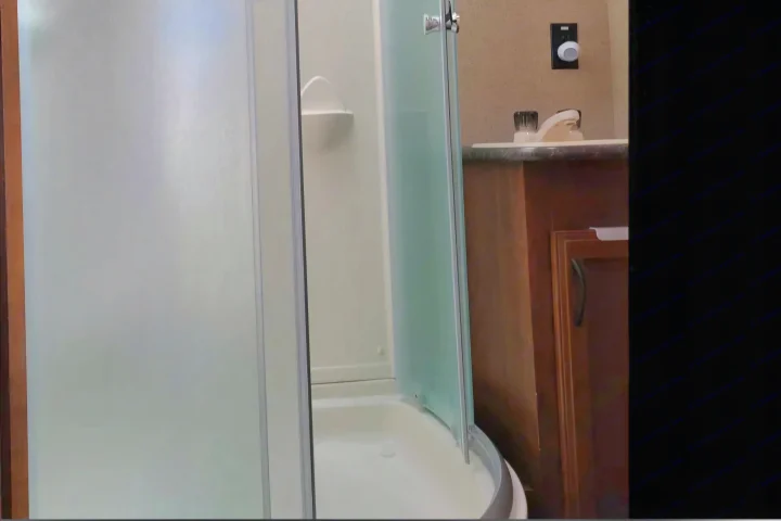 Compact RV rental bathroom showcasing a functional shower stall with a corner shelf, and a vanity with a sink and faucet.. Jayco Jay Flight SLX 2016