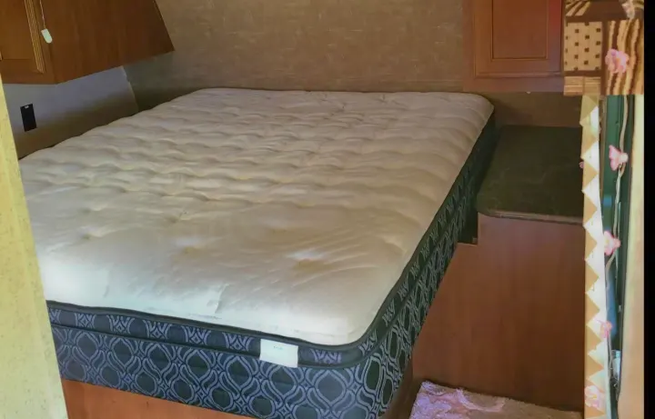 RV rental: Cozy bedroom with a large mattress, featuring a patterned base, overhead cabinets, and a built-in nightstand.. Jayco Jay Flight SLX 2016