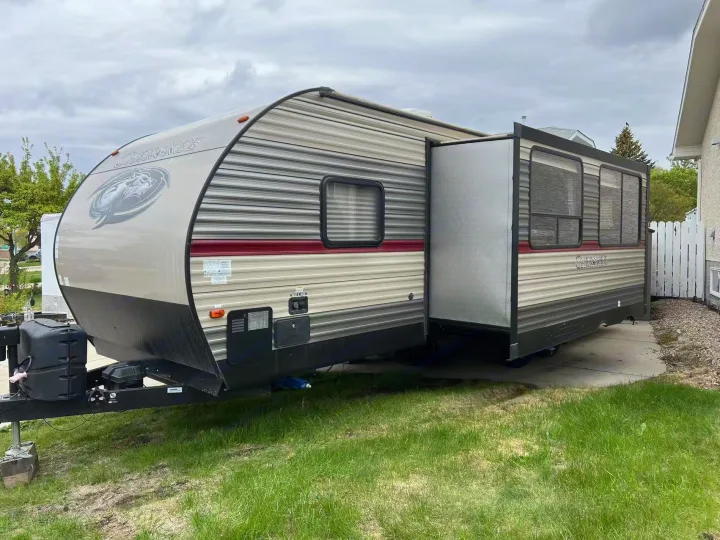 Cherokee travel trailer parked on a driveway with slide-out extended, great for an rv rental.. Forest River Cherokee 2018