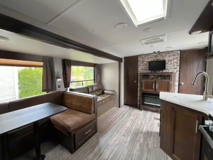 Modern RV rental interior: spacious living, dining, and kitchen areas. Experience comfort on the road.. Forest River Cherokee 2018