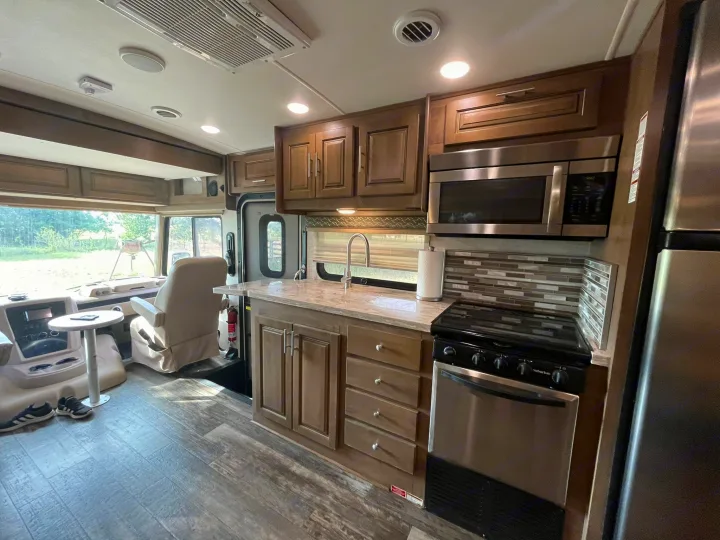 Cozy RV rental interior: modern kitchen, driver's area, wood floors. Ready for your next adventure!. Georgetown GT5 2019