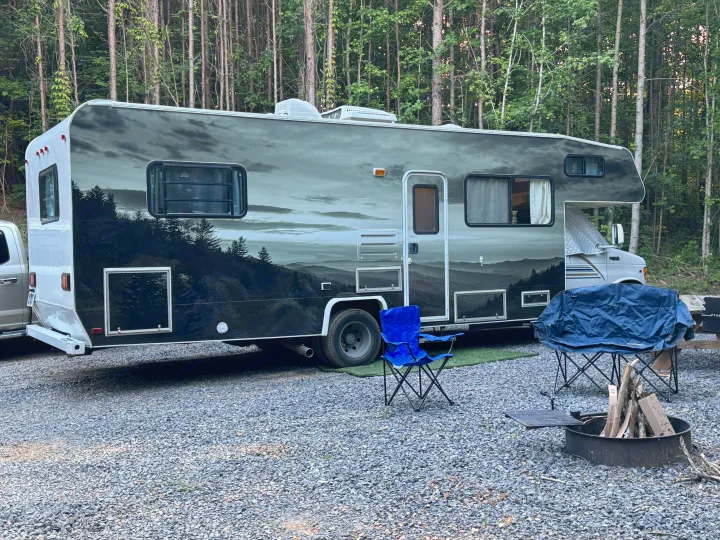A unique mountain-mural RV rental is perfectly set up for camping on a gravel site, with. Coachmen Leprechaun 2000