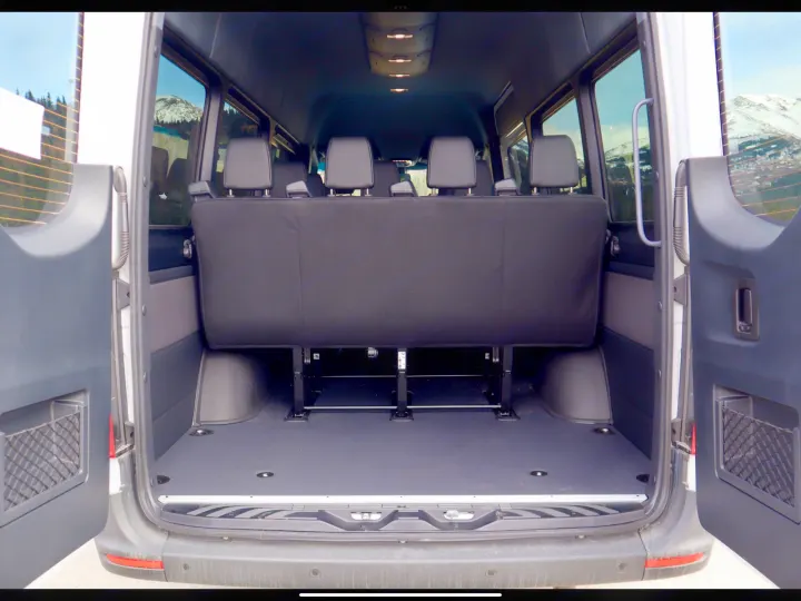 Spacious RV rental van interior features a rear bench seat and open cargo area, perfect for adventure.. Mercedes- Benz Sprinter 2025