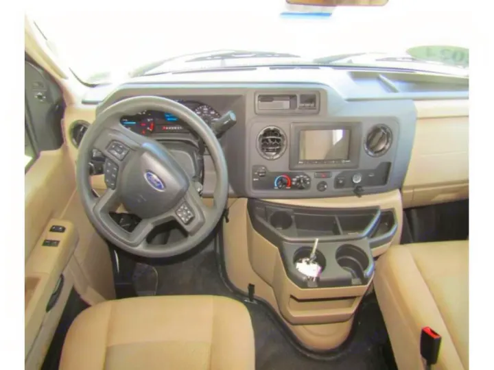 RV rental interior: A detailed view of the driver's area, including the dashboard, Ford steering wheel, and infotainment system.. Thor Chateau 2024