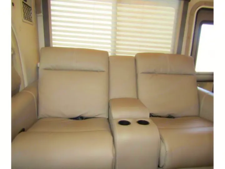 RV rental's cozy interior showcases comfortable beige recliners and window blinds.. Thor Chateau 2024