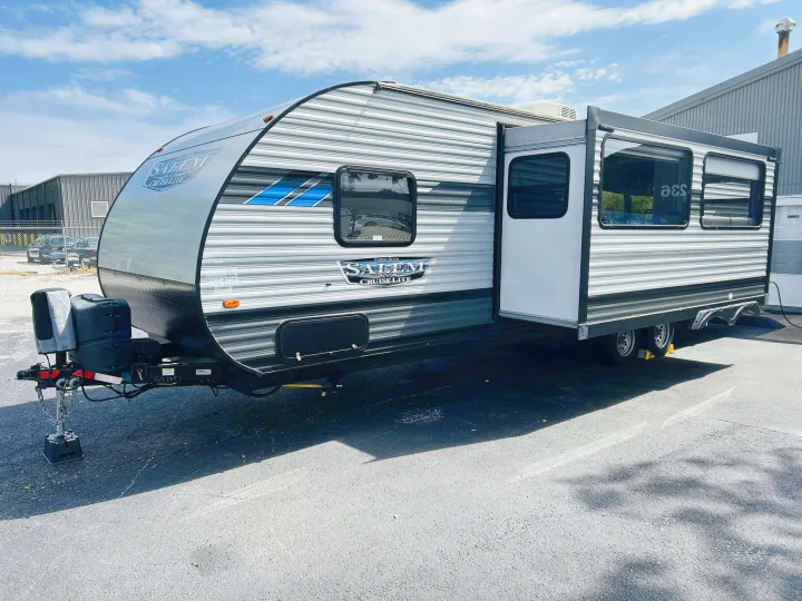 Ready for adventure: a modern gray and white Salem Cruise Lite travel trailer RV rental, with a slide-out extended.. Forest River Salem Cruise Lite 2022