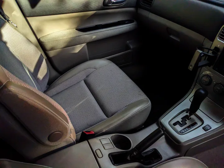 RV rental interior: passenger seat, dashboard, center console with gear shifter & handbrake. Ready for adventure.. Subaru Forester 2007
