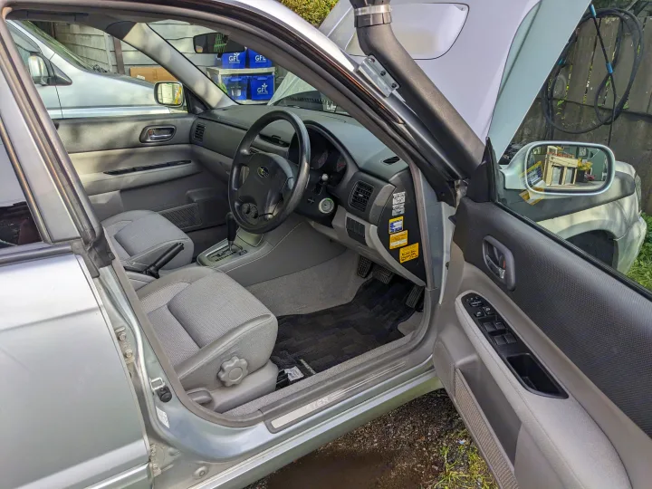 Silver Subaru Forester's interior with open door, hood, and snorkel, ready for adventure, unlike typical **rv rental** vehicles.. Subaru Forester 2007