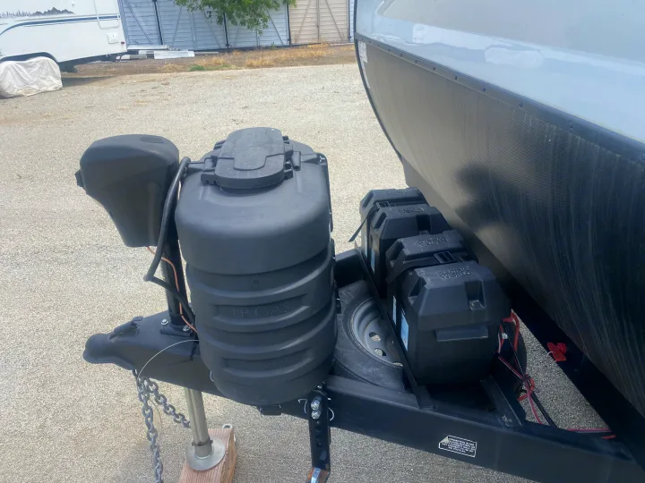 Detail of an RV rental's tongue, showing LP gas tanks, multiple batteries, and a spare tire.. Coachmen Northern  Spirit Ultra Lite 2024